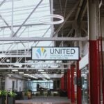 Image of a refurbished industrial building with plants and seating areas. A sign in the center reads "United Theological Seminary of the Twin Cities."